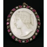 An early 19th century cameo pendant,depicting a lady looking left, to a ribbon style frame, set with