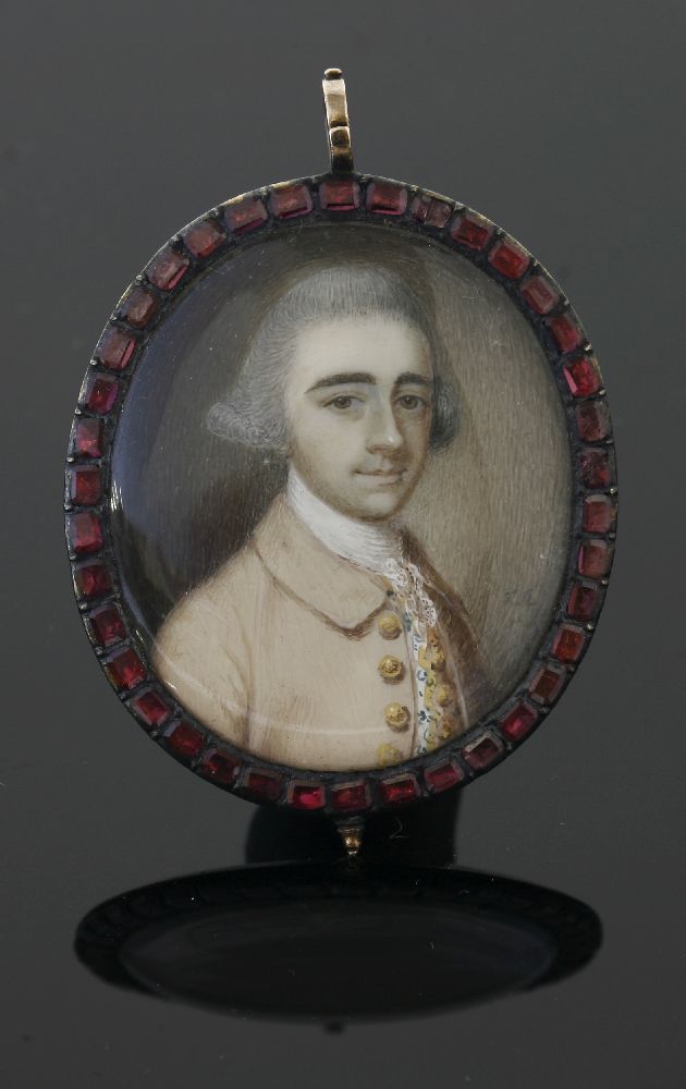 A gold mounted portrait miniature pendant with a garnet border, late 18th century, the painted - Image 2 of 2