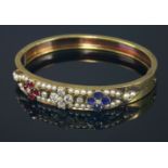 A Victorian diamond, sapphire, ruby and split pearl gold bangle, c.1890,a tapering flat section