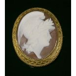 A late Victorian carved shell cameo brooch,depicting the profile of Mercury in white to a light