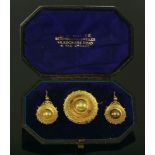 A cased late Victorian gold brooch and earring shield form suite,the circular shield style brooch