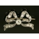 A late Victorian diamond set bow brooch,with an old European cut diamond, milligrain set to the