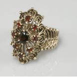 A marquise shaped garnet cluster ring, with pierced head and shoulders, tested as approximately