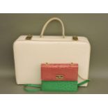 A 1950s white patent vanity case, and an F Pinet green ostrich skin printed leather and pink