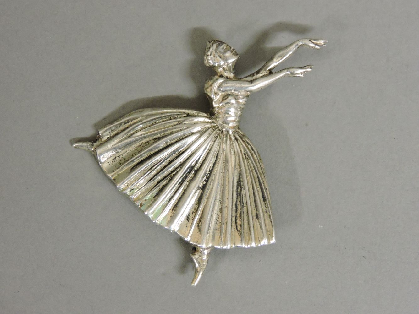 A silver ballerina brooch, designed by Frederick Massingham for D H Phillips, marks worn, 7cm high