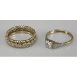 A single stone diamond ring, marked 9ct palladium, and a 9ct gold diamond set full eternity ring