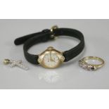 A 9ct gold ladies Accurist mechanical strap watch, a 9ct gold diamond set cross, and a five stone