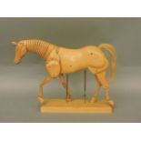 A beech artist's figure of an articulated horse, on stand