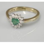 A 9ct gold heart shaped emerald and diamond cluster ring