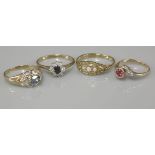 A 9ct gold blue and topaz diamond ring, a 9ct gold sapphire and diamond oval cluster ring, a ruby