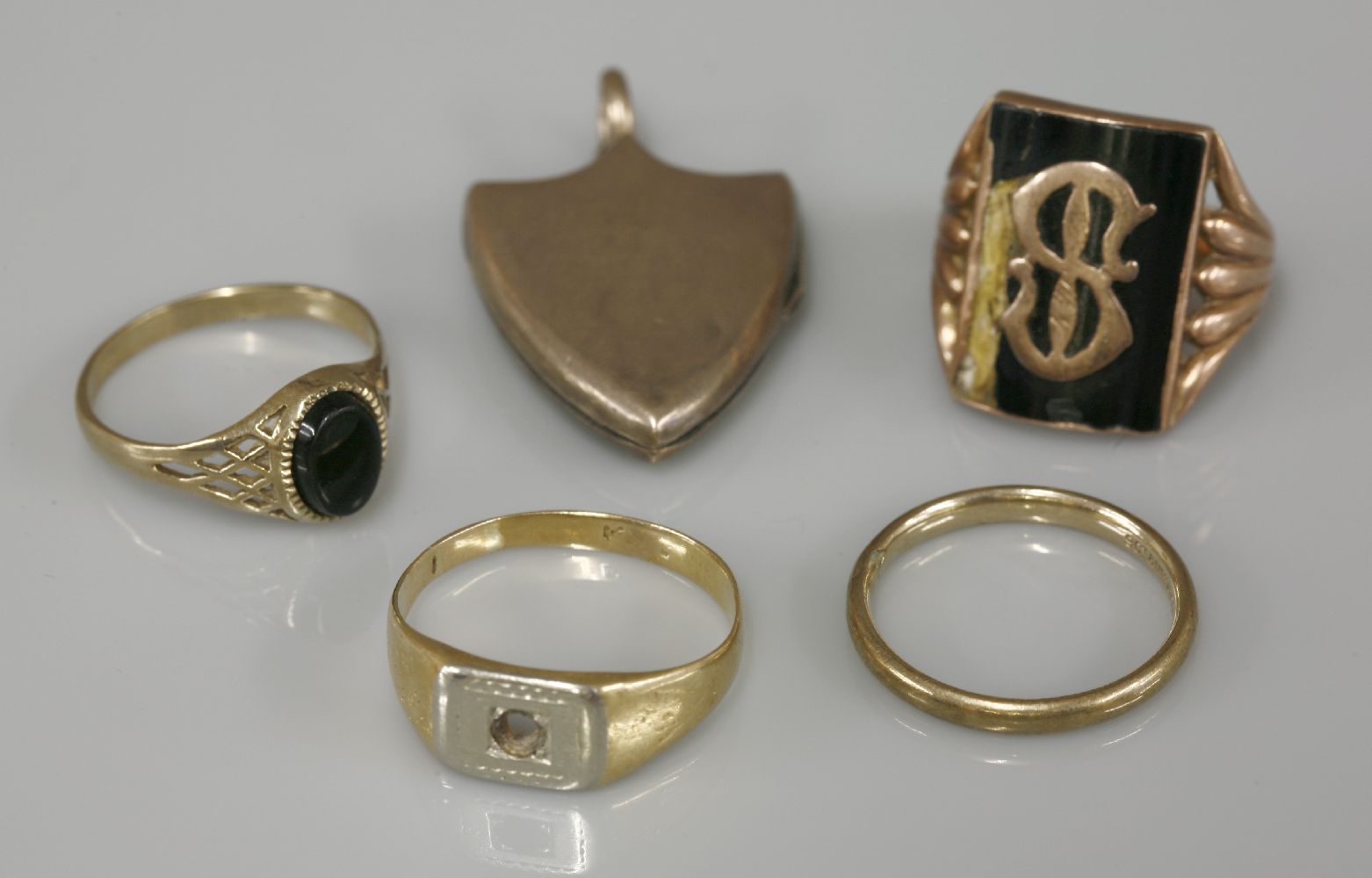 A gold initial ring, damage, marked 9ct, a 9ct gold onyx signet ring, a two colour ring, stone