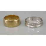 A 22ct gold wedding ring, and a white gold wedding ring marked 750