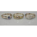 A 9ct gold sapphire and diamond cluster ring, with diamond set shoulders, a 9ct gold lozenge