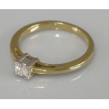 A single stone princess cut diamond ring, marked 750