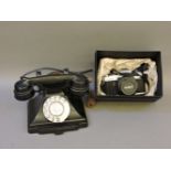 A black bakelite telephone, with pull out drawer, and a Minolta X-500 SLR camera