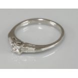 An 18ct white gold single stone princess cut diamond ring, with tapered baguette cut diamond