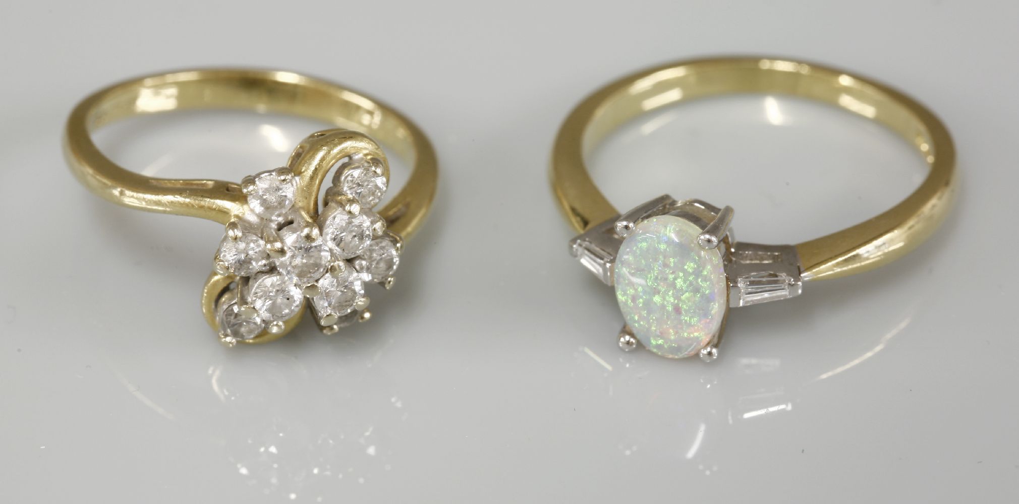 An 18ct gold single stone opal ring, with tapered baguette cut diamond shoulders, and an 18ct gold