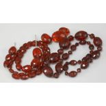 An olive shaped faceted bakelite bead necklace, and a shorter example with spacer beads