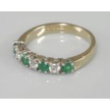 A 9ct gold emerald and diamond half eternity ring