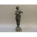 A bronze figure of a woman with flowers, indistinctly signed, 34cm high