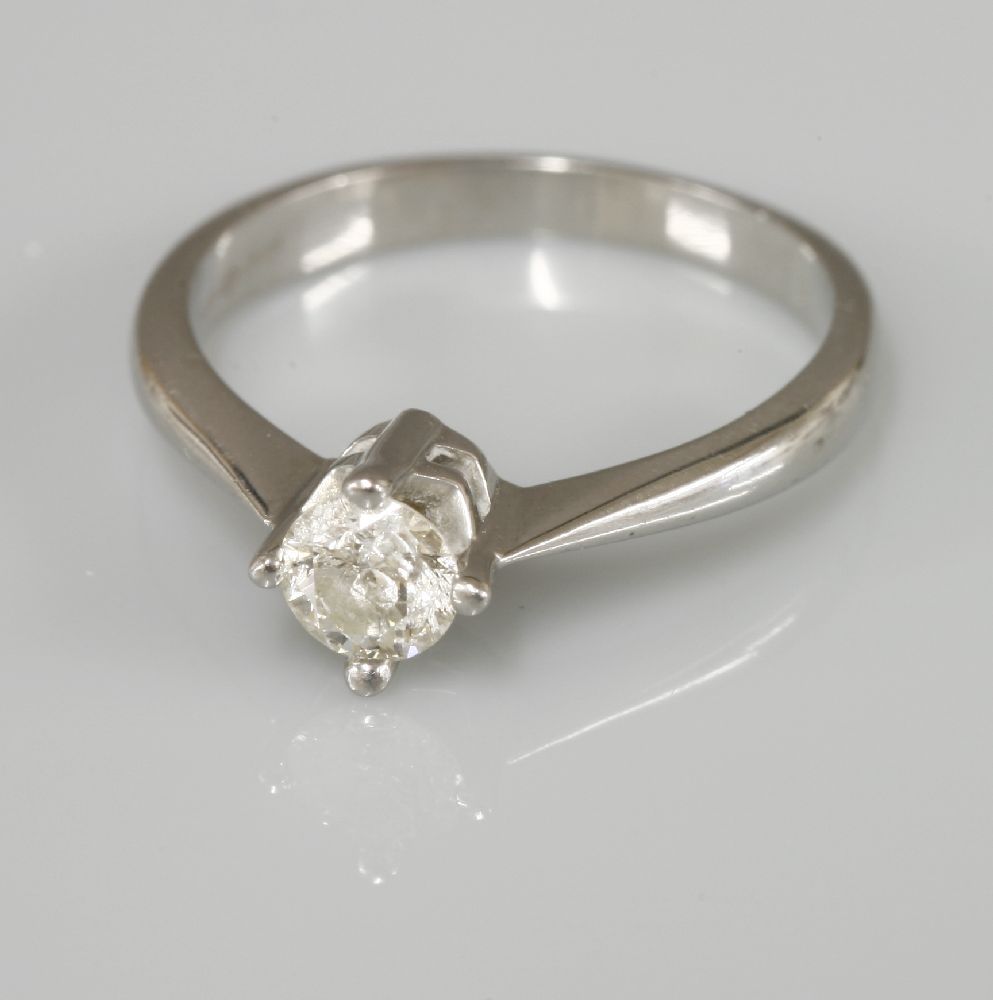 A platinum single stone diamond ring, with a brilliant cut diamond with an estimated weight of 0.