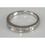 A 9ct white gold baguette cut diamond channel set half eternity ring, 0.25ct stated weight