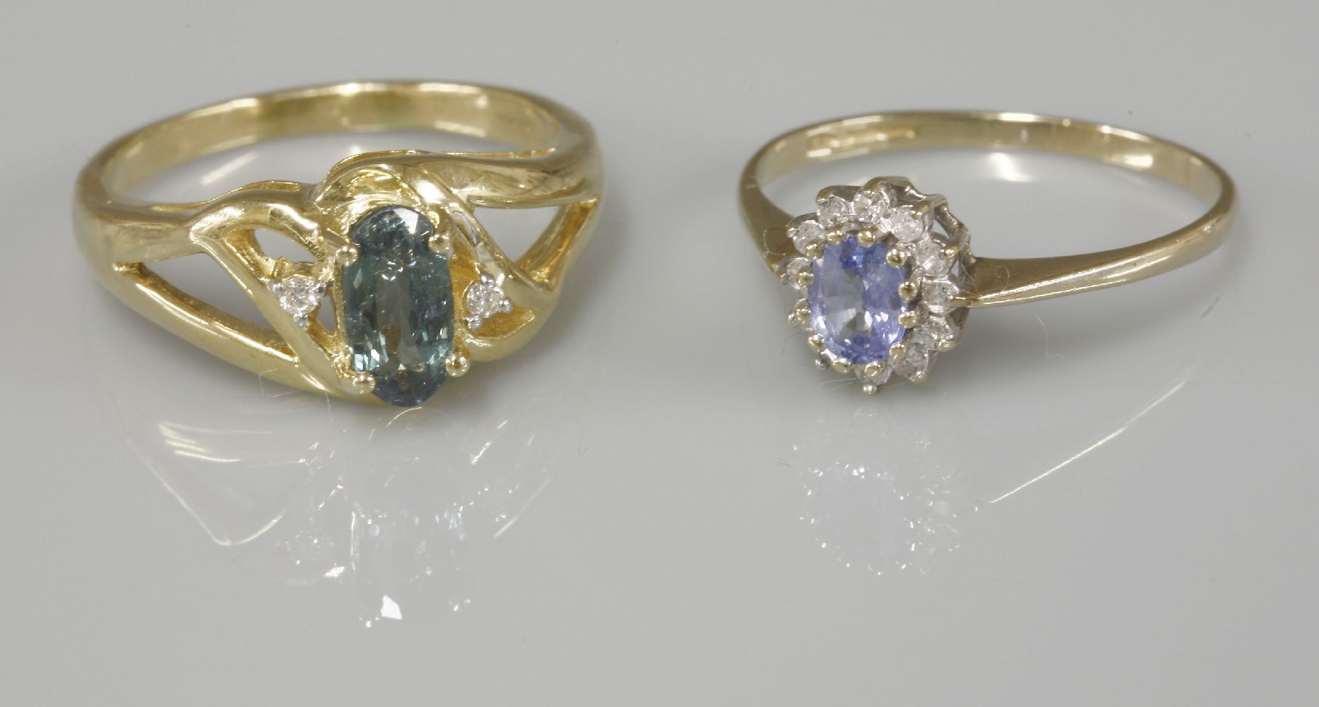 A 9ct gold sapphire and diamond oval cluster ring, and an 18ct gold tourmaline ring with diamond set