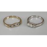 An 18ct white gold three stone diamond ring, and a 9ct gold sapphire and diamond half wishbone