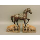 An old leather horse, two carved bookends, a book 'Japanese Views', and 'Thirty Illustrated