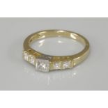 An 18ct gold single stone princess cut diamond ring, rub set in a white collet, with end set