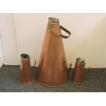 Three copper lined jugs, each of conical form, and a large Chinese brass dish