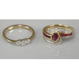 An 18ct gold ruby crossover ring, with channel ruby and diamond shoulders, and a 9ct gold three