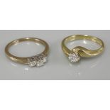 An 18ct gold single stone diamond crossover ring, and a 9ct gold three stone diamond ring