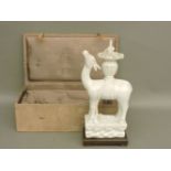 A Chinese blanc de chine model of a deer, a basket of flowers strapped to its back, 34cm high, on