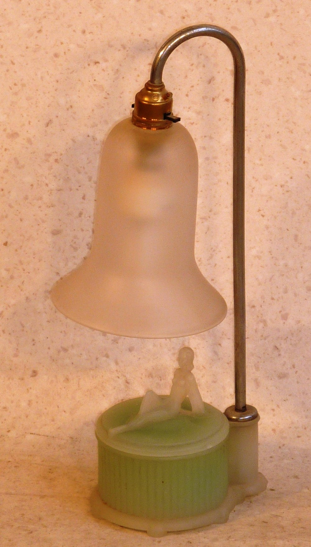 An Art Deco period glass Lamp, the bell shaped Shade above a circular green glass box, the lid