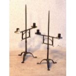 A pair of wrought iron two light Candela