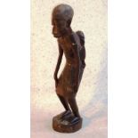 An early/mid 20th Century East African hardwood Carving, young child being carried on the back of a