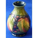 An early 20th Century William Moorcroft baluster shaped Vase tube lined and hang decorated in the