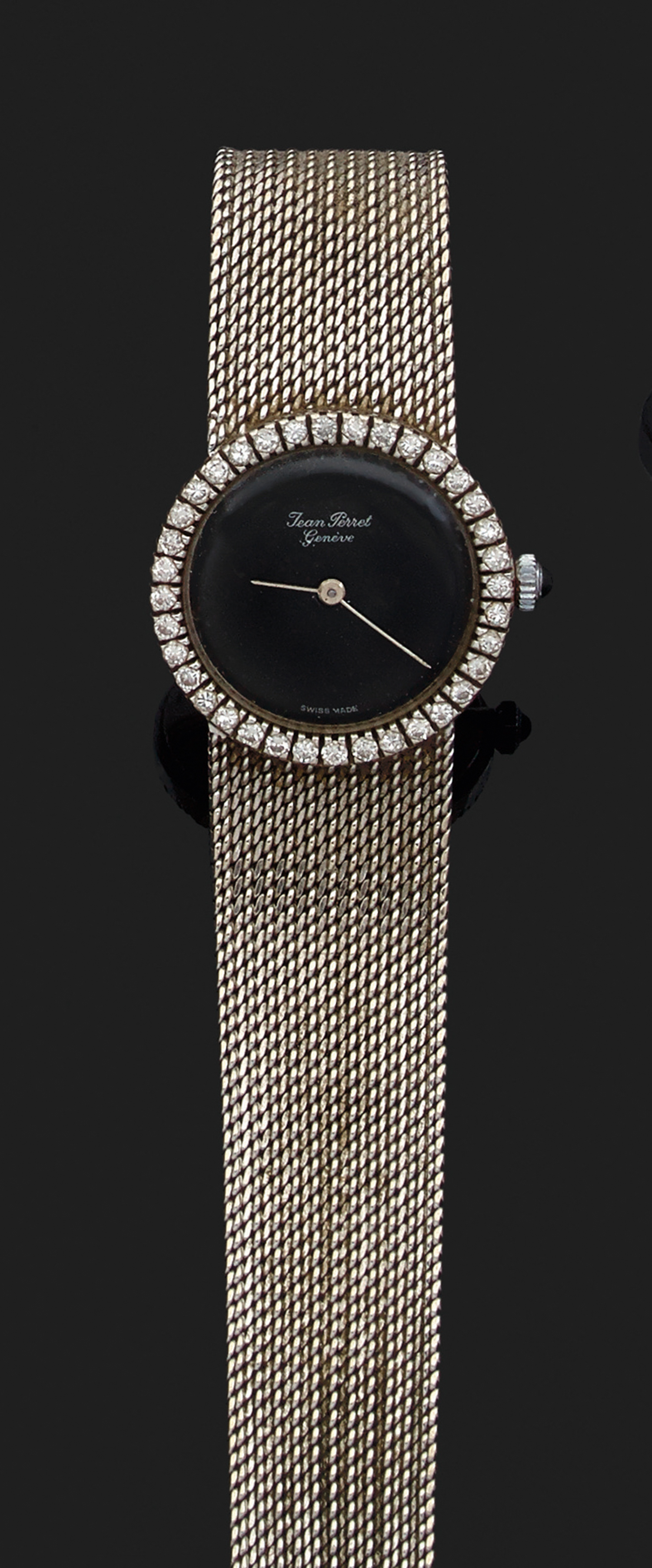 JEAN PERRET GEN ÈVE VERS 1970 Montre bracelet de dame en or gris. Boîtier rond avec lunette sertie