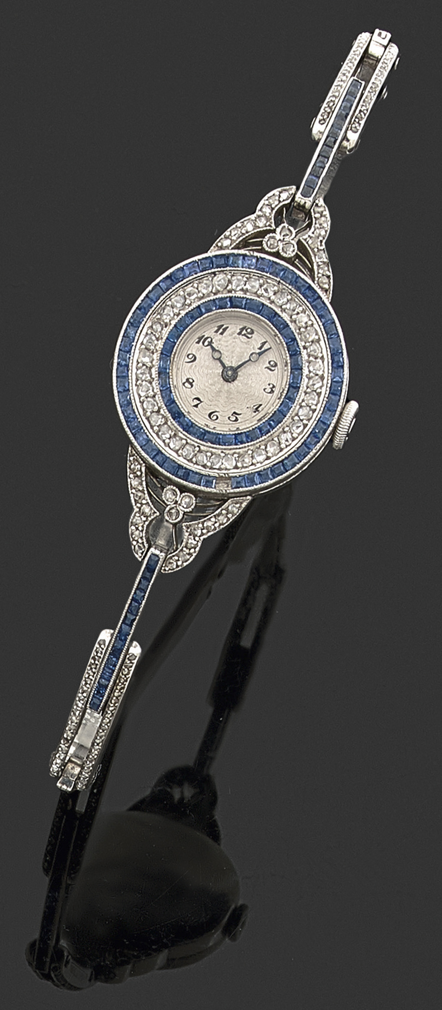 ANONYMEVERS 1920Elégante petite montre bracelet de dame en or gris avec boîtier rond en serti perlé,