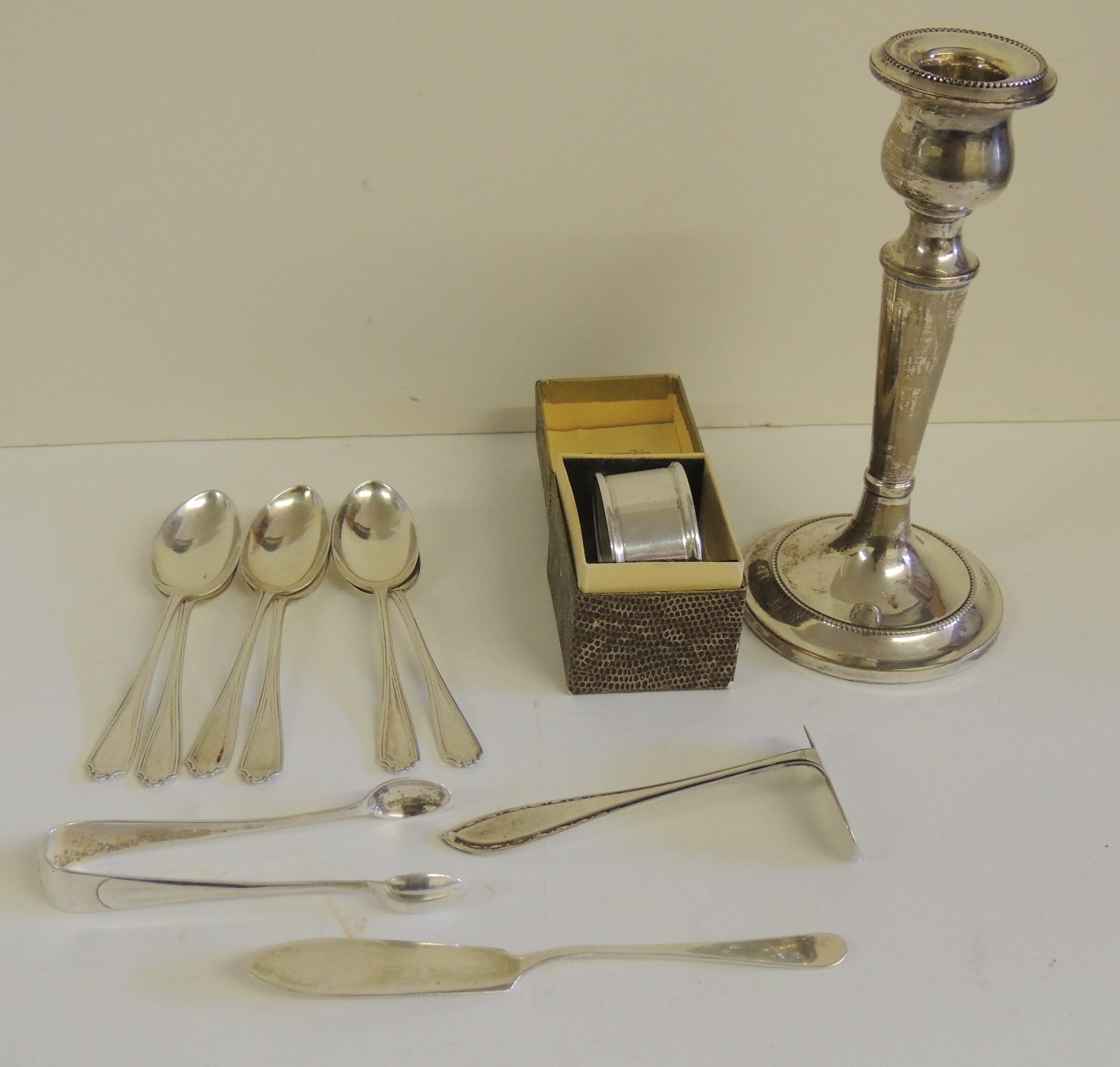 A silver candlestick, hallmarked for Birmingham 1932, weighted base, a boxed silver napkin ring, six