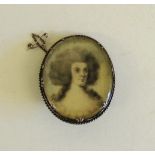 A large oval portrait miniature brooch, set in silver metal. The portrait, watercolour on ivory,