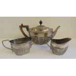A Victorian silver teapot, hallmarked London 1895, Wrythen fluted body with ebonised knop and handle