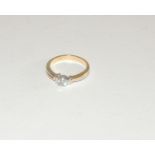 An 18 ct gold diamond solitaire ring, the band and mount, white and yellow gold, the diamond quarter