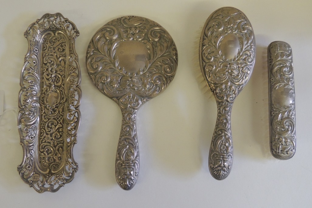 A silver pin tray, hallmarked for Birmingham 1894, repousse floral and C scroll decoration with