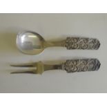 A pair of Continental .830 silver serving fork and spoon, with pierced rococo scroll and pineapple