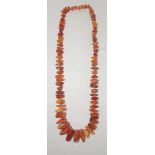 An AMBER rough chunk bead necklace, 16 inch length, beads individually knotted and mostly mottled