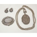 A Victorian oval silver locket, hallmarked for Birmingham 1880 with engraved foliate decoration,