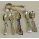 An assortment of silver tea spoons, including three sets of six, a matched set of six, two groups of