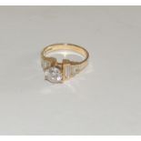 A 9ct gold, ladies dress ring, set with a central cubic zircon and baguette cut CZ's to the